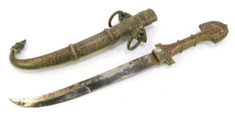 A Moroccan Koummya dagger, the scabbard and hilt intricately decorated with floral motifs, scrolls, etc., with some colour work, curved blade, 42cm long overall, blade length 27cm long.