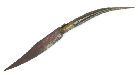 A Spanish folding Navaja knife, the ebonised handle inlaid with brass, a tapering blade engraved with leaf motifs in red, 49cm long overall.