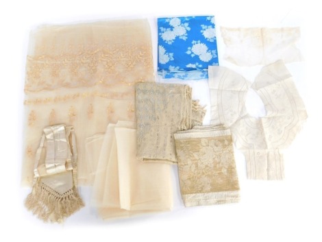 A group of fabric, comprising a Japanese blue Kanebo, section of lace, a cream silk sash with tassels, embroidered metallic stole, cream Broderie Anglaise embroidered remnant possibly from the collar of a shirt, a woven cream shawl, length of tulle, and a