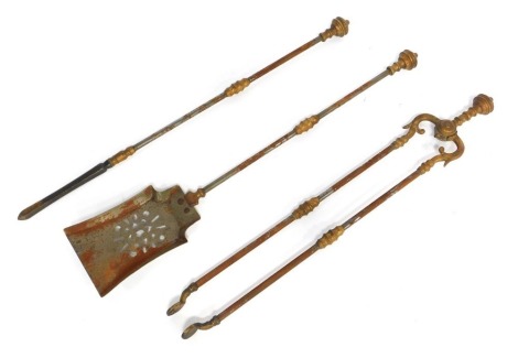 A cast metal three piece fireside companion set, comprising tongs, shovel and poker.