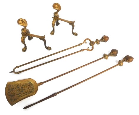 A cast metal fireside companion set, comprising poker, tongs, shovel and pair of fire dogs, each handle cast with a ball and claw finial.