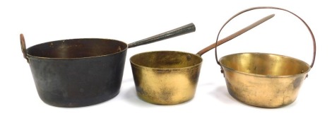 A collection of copper and brass ware, to include a brass helmet shaped coal scuttle, copper kettle, brass jam pan, etc. (a quantity)