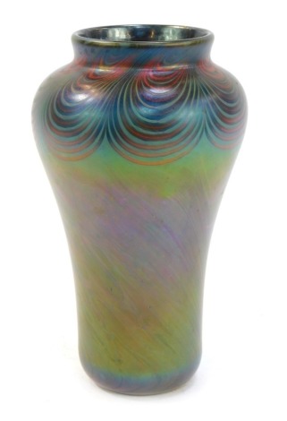 A 20thC Donald Carlson lustre glass vase, of cylindrical tapering form with flared neck, decorated with concentric red banding against a mottled green ground, number 3292, signed, 18cm high.