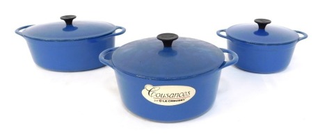 Three Cousance by Le Creuset blue cast iron casserole pots, 24cm diameter, 19.5cm diameter and an oval pot, 26cm wide. (3)