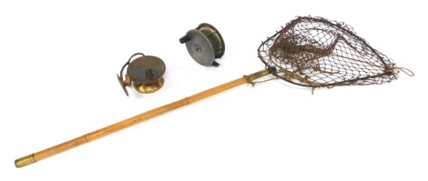 Two vintage fishing reels, comprising a brass Malloch's Patent side cast reel, and an early 20thC salmon fly reel, together with a vintage landing net. (3)