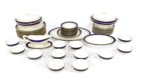 A Royal Worcester porcelain Regency pattern dinner service, comprising an oval meat platter, pair of vegetable tureens and covers, oval open dish, sauce boat on stand, twelve dinner and dessert plates, twelve soup cups and saucers.