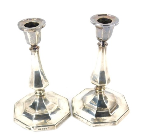 A pair of George V loaded silver candlesticks, of octagonal baluster form, Sheffield 1912, 35.76oz