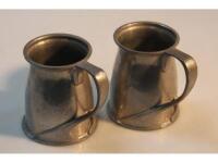 A pair of Tudric pewter tankards designed for Liberty & Co