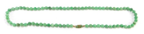 A jade bead necklace, on a jade set yellow metal clasp, stamped 9ct, 104.5g.