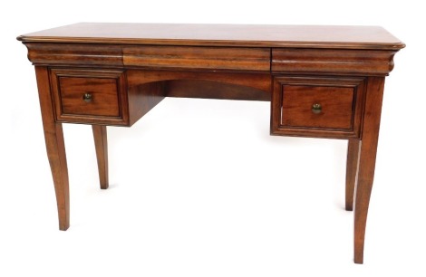 A Biedermeier style mahogany kneehole dressing table, with three cushion drawers, over a pair of square drawers, raised on out swept legs, 78cm high, 125cm wide, 48.5cm deep.