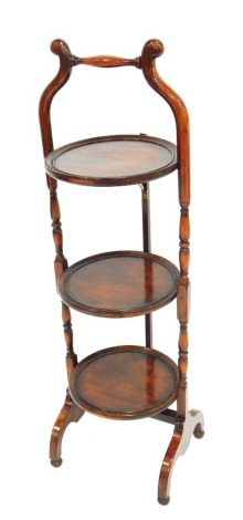 An early 20thC mahogany three tier folding cake stand, 86cm high.