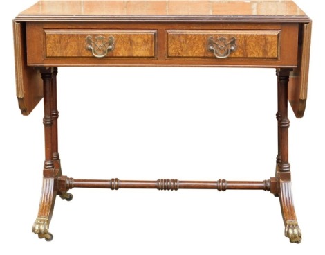 A mid century mahogany and burr wood sofa table, the top with a moulded edge, above two frieze drawers, on turned columns, on splayed legs united by turned stretchers, 49cm high.