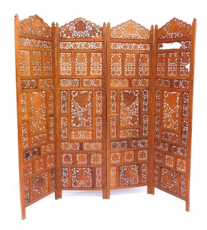 An Eastern carved hardwood four fold screen, with pierced leaf decoration, 182cm high, 200cm wide.