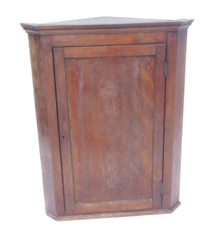 A 19thC oak hanging corner cabinet, the top with moulded edge above a paneled door, 102cm high, 74cm wide.