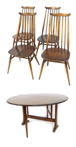 An Ercol dark elm drop leaf dining table, with circular top, 71cm high, the top 126cm diameter, together with four chairs, each with a slatted back, solid seat, on tapering cylindrical legs.