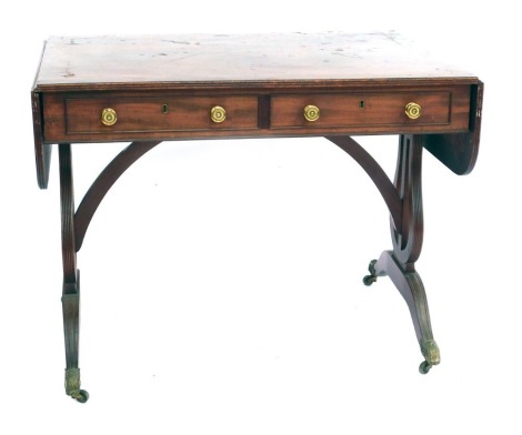 A 19thC mahogany and inlaid sofa table, the rectangular drop leaf top above two frieze drawers (one lacking) and two dummy drawers verso, raised on lyre shaped end supports, on scroll legs, with foliate scroll capped castors, 71cm high, 92cm wide, 64cm de