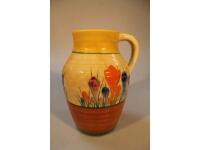 A pottery vase painted in the Clarice Cliff crocus pattern manner