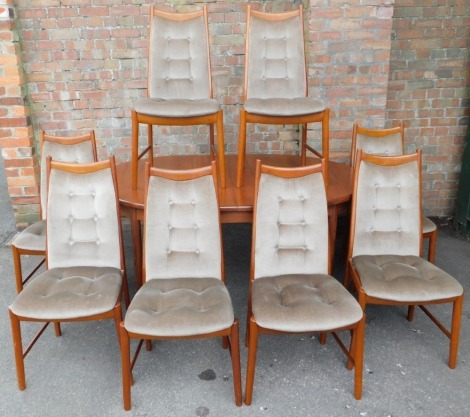 A late 20thC teak oval draw leaf dining table, with one additional leaf, raised on turned legs, 73cm high, 162cm wide, 208cm extended, 112cm deep, together with eight single dining chairs, with button draylon overstuffed backs and seats.