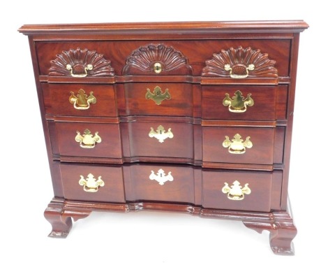 A 20thC American mahogany chest, stamped Thomasville, the top with a moulded edge, above four inverted break front drawers, raised on ogee feet, 85cm high, 97cm wide, 49cm deep.