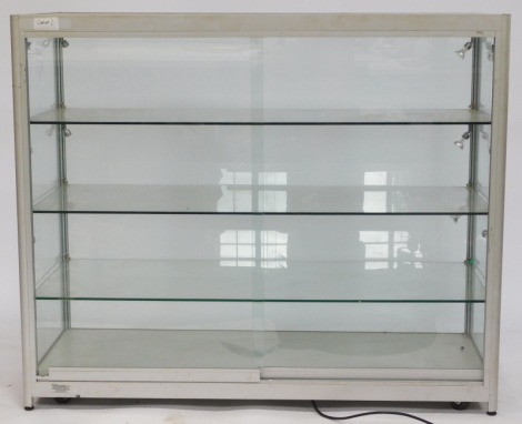 A glass fronted shop display cabinet, with four tiered shelves, 100cm high, 120cm wide, 50cm deep.