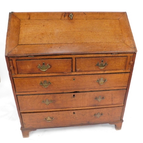 A George II walnut bureau, with cross banding, the fall flap opening to reveal nine recesses and ten drawers with a slide centrally above a vacant compartment, over three long graduated drawers, raised on bracket feet, 102cm high, 94cm wide, 55cm deep.