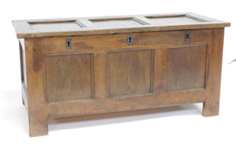 An 18thC oak church coffer, with a triple panelled front and triple lock plate, raised on stiles, 52cm high, 108cm wide, 48cm deep.