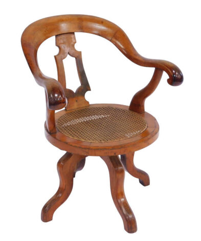 A Victorian mahogany horse shoe back captain's chair, with a carved splat and cane seat, raised on four cabriole legs, 61cm wide.