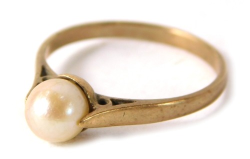 A cultured pearl dress ring, the single pearl in tension setting on a yellow metal band, stamped 9ct, ring size N, 1.7g all in.