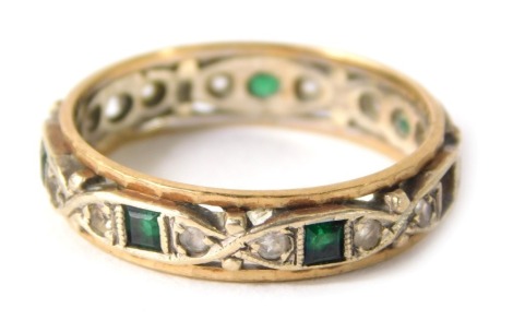 A 9ct gold eternity ring, set with design of white and green paste stones, set in white gold with a pleated yellow gold outer border, ring size Q½, 3.5g all in.