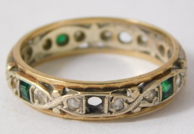 A 9ct gold eternity ring, set with design of white and green paste stones, set in white gold with a pleated yellow gold outer border, ring size Q½, 3.5g all in. - 2