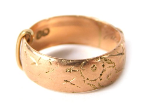 A 9ct gold wedding band, of hammered and etched buckle design, ring size L½, 3.4g all in.