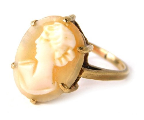 A shell cameo dress ring, the oval cameo depicting maiden looking left in six claw basket setting, on a yellow metal band, stamped 9ct, ring size M, 3.2g all in.