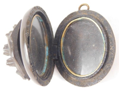 Two carved jet oval brooches, comprising a oval example with yellow metal buckle outer border and central harp, 4cm high, a carved molten lava oval pendant with raised flowers, 4cm high, and a silver rose brooch. (3) - 2