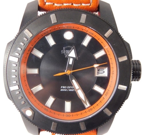 A Shield Pro Diver diving watch, with a black outer casing, and an orange second dial, 200 metre/660 ft, with date dial, on an orange leather strap, the dial 4.5cm diameter, boxed.