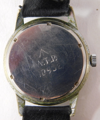 A 1940s APT military issue wristwatch, with a silvered numeric dial, seconds dial and cream markers, in a stainless steel case, with military arrow and bearing the initials ATP, 18932, on black leather strap, the dial 3cm diameter. - 3