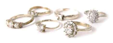 Six silver dress rings, each stone set, to include clusters and three stones. (6)