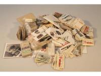 A collection of loose cigarette cards and cigarette packets.