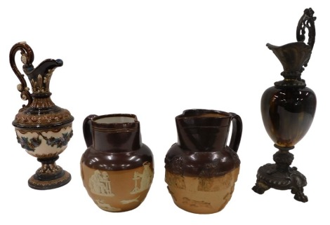 Two Royal Doulton stoneware brown glazed jugs, a Continental porcelain Majolica ewer, and a Continental ewer with gilt spelter mounts. (4)