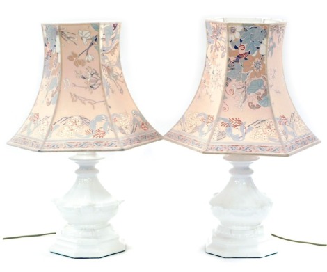 A pair of white ceramic table lamps, each with brass fittings, and an Oriental style shade, the lamps 40cm high.