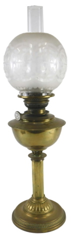 A late 19th/early 20thC oil lamp, with canted reeded column and domed foot, and a partly etched shade decorated with fleur de lys, 42cm high.