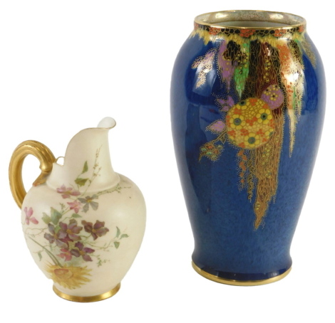 A Royal Worcester blush ivory porcelain jug, decorated with flowers, and a crown Devon lustre vase, decorated in the oriental style on a mottled blue ground.