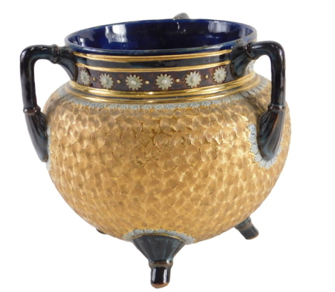 A Doulton Lambeth tyg or three handled cauldron, with incised decoration in gilt, within brown and blue borders, impressed marks to interior, 17cm high.