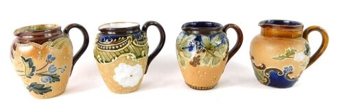 Four miniature Doulton Lambeth stoneware jugs, varying patterns, 9cm high. (4)