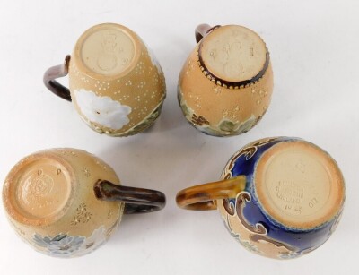 Four miniature Doulton Lambeth stoneware jugs, varying patterns, 9cm high. (4) - 3