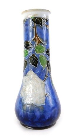 A Royal Doulton stoneware vase, decorated with roses and leaves within tube lined borders, on a mottled blue ground, impressed marks to underside, decorator's initials BN, 25cm high.