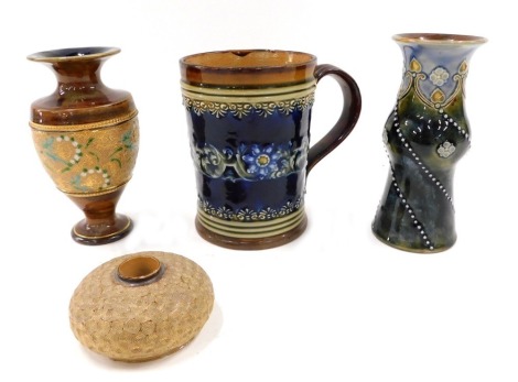 Four pieces of Doulton and Royal Doulton stoneware, comprising tankard, 12cm high, Art Nouveau style vase, 14cm high, match strike, 4cm high, and a brown mottled vase, 15cm high. (4)