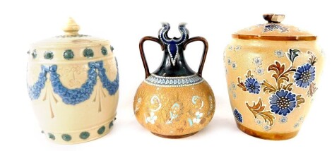 Three items of Royal Doulton stoneware, comprising ginger jar and cover, 13cm high, a brown and floral glazed ginger jar and cover, 15cm high, and a two handled vase, 13cm high. (3)