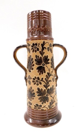 A Doulton Lambeth stoneware vase, on a brown floral ground, with two handles, 33cm high.