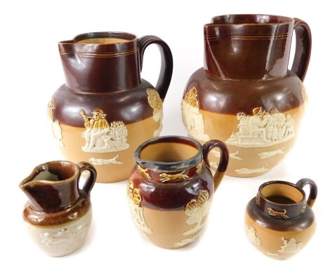 Five Royal Doulton stoneware jugs, the largest 19cm high, the smallest 5cm high, one with silver collar.