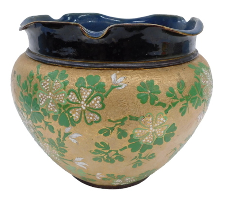 A Doulton Lambeth ware planter, with a blue and brown glazed and fluted rim, on a brown body with green and white speckled flowers, stamped to underside, 20cm high.